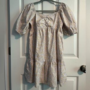 Billabong dress that has a blue-gray background with golden yellow flowers